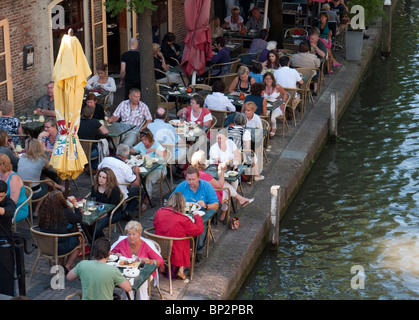 Busy outdoor summer cafes and restaurants beside canal Oudegracht in central Utrecht in the Netherlands Stock Photo