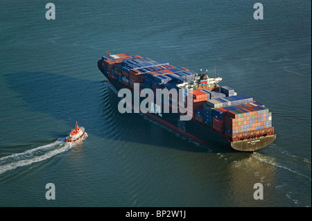 aerial view above pilot boat meeting fully loaded  APL Philippines container ship San Francisco bay Stock Photo