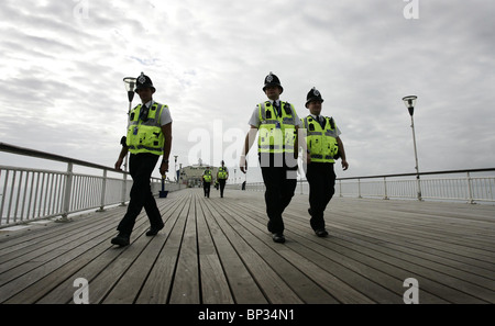 Police officers walk along Bournemouth Pier prior to the Labour Party Conference. Picture by James Boardman. Stock Photo