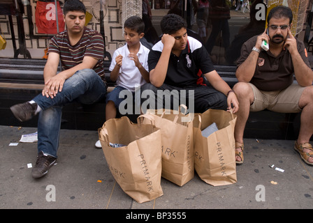 Shoppers waiting outside of primark shop Oxford Street London Stock Photo