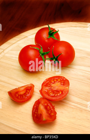 Cherry tomatoes on a cutting board isolated on white background Stock ...