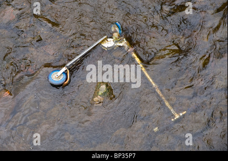 Child's scooter thrown in river Stock Photo