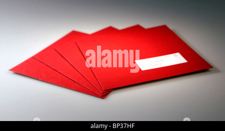 Red Christmas envelopes on a gray paper background Stock Photo