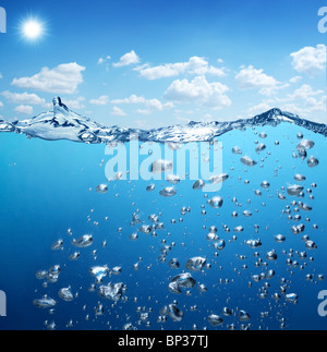 Air bubbles rise from the bottom of the ocean to the surface. Stock Photo