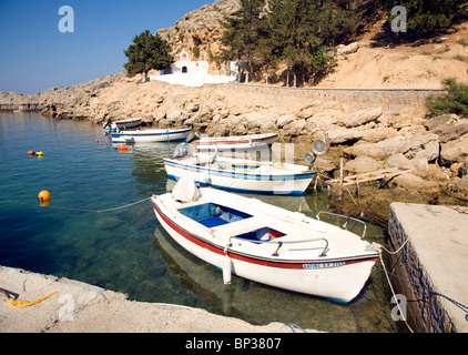 Boats and church St Paul's Bay, Agios Pavlos, Lindos, Rhodes island, Greece Stock Photo