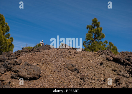 Moon rises behind the volcanic cliff Stock Photo