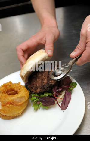 A meal of burger and chips is served in a pub. Stock Photo