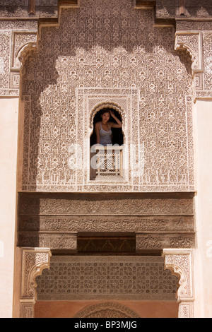 Woman looking out of window at Ben Youssef Medersa, Marrakech Stock Photo