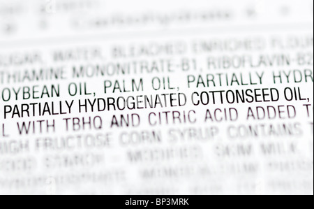 Part of the ingredients list from a package of cupcakes highlighting partially hydrogenated oils (trans fats). Stock Photo