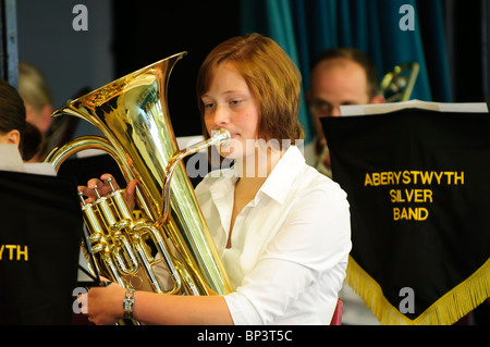 Brass band or Silver band- a young woman musician playing french horn, Aberystwyth Wales UK Stock Photo