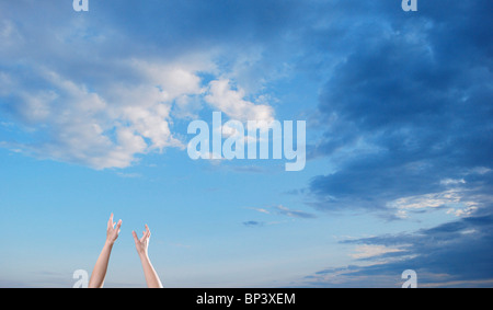 hope reach hands blue sky clouds Stock Photo