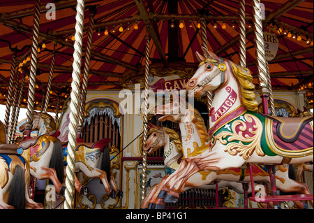 Steam Galloping horse carousel fairground ride at a  steam fair in England Stock Photo
