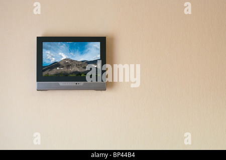 Liquid-crystal television receiver on wall. Picture on screen. Copy space Stock Photo