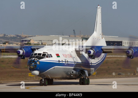 Air transport. Ruby Star Airways Antonov An-12 turboprop cargo plane taxiing for departure. Front view close up of aircraft with spinning propellers. Stock Photo