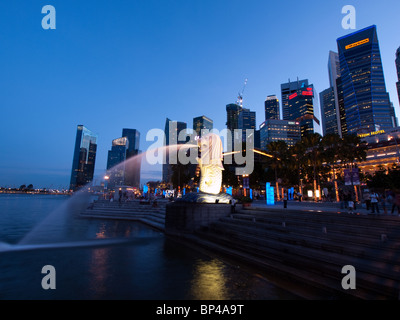 Singapore's iconic Merlion statue in Merlion Park at dusk. Stock Photo