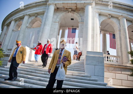 Veterans pass out American flags to visitors at the Arlington National Cemetery Memorial Amphitheater on Memorial Day. Stock Photo
