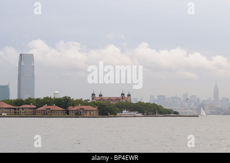 Ellis Island, the Manhattan skyline and the Goldman Sachs tower in Jersey City as viewed from Liberty Island in New York harbor. Stock Photo