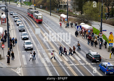 Cars, trams and people on Solidarity Avenue (Aleja Solidarnosci), one of the main thoroughfares in Warsaw Poland Stock Photo