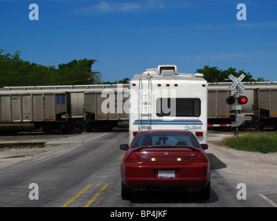 Waiting at railroad crossing Stock Photo