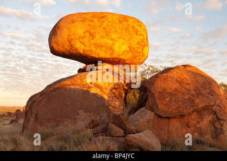 Balancing rock at the Devils Marbles near Wauchope in the Northern Territory at sunset Stock Photo