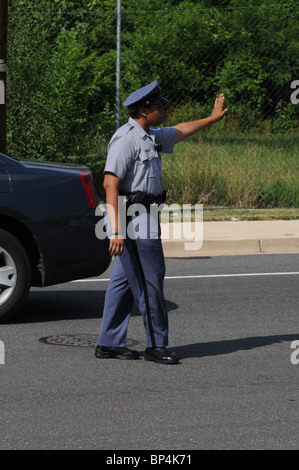 Policewoman directing traffic Stock Photo