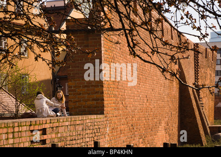 Two friends chatting on Old Town defensive walls, Warsaw Poland. Stock Photo
