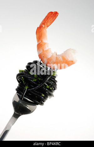 The Red Shrimps on the fork w black spaghetti Stock Photo