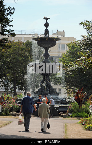 Visitors walk past the fountain in The Old Steine Brighton city centre UK Stock Photo