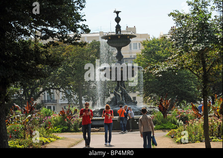 Visitors walk past the fountain in The Old Steine Brighton city centre UK Stock Photo