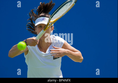 Female tennis player in action hitting forehand. Stock Photo