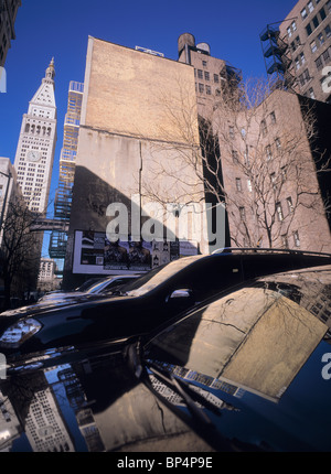 Urban composition of typical New York buildings and its reflections in parked cars. Stock Photo