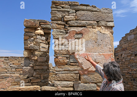 Basilika, the tour guide, pointing at antique plaster on a wall, archaeological excavation, island of Delos, Cyclades, Greece Stock Photo