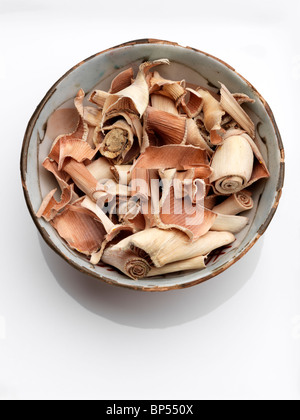 A bowl of dried lemongrass on a white background Stock Photo