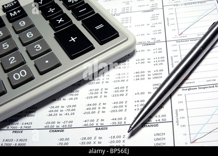 Calculator, steel pen and financial data with graphs. Stock Photo