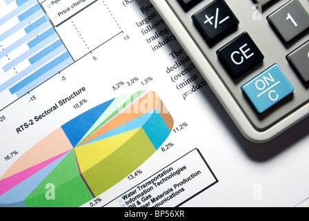 Calculator and printed stock data with diagrams. Stock Photo
