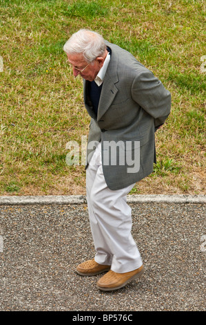 Overhead view of old man walking slowly along pavement - France. Stock Photo