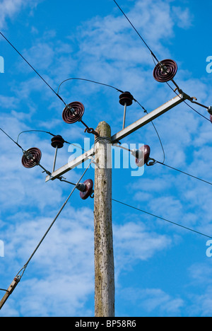 power cables set against blue sky Stock Photo