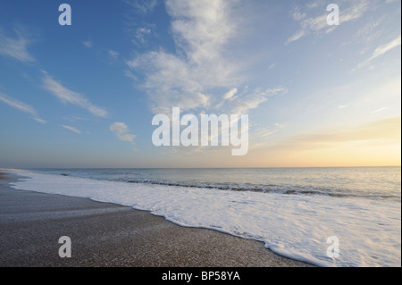 The tide washing over pebbles at Burton Bradstock beach on the Jurassic coastline, Dorset. Stock Photo