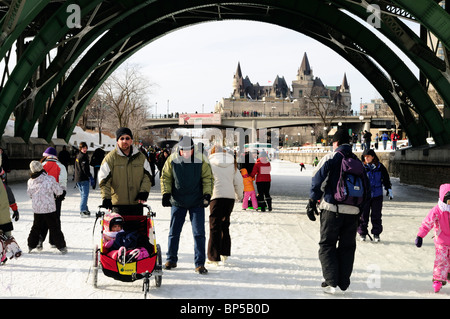 People Enjoying Ice Skating On The Worlds Longest Ice Rink, At The Laurier Bridge Rideau Canal Ottawa, Canada Winterlude Celebrations Stock Photo