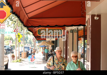 An elderly couple going window shopping in Orange County's antique products center walking past the Orange Circle Antique Mall. Stock Photo