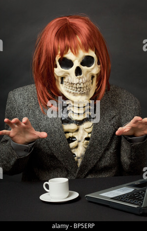 The amusing skeleton with red hair tries to frighten us Stock Photo