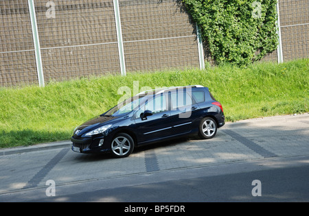 Peugeot 308 SW 1.6 HDI - MY 2010 - dark blue metallic - French popular lower-medium class car, segment C - park space Stock Photo