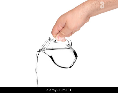 Hand pouring water from pitcher Stock Photo