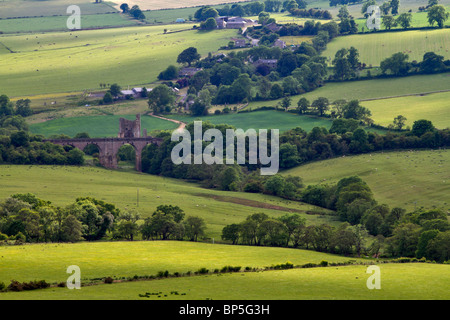 Northumberland countryside and the village of Edlingham. The ruins of Edlingham Castle can be seen near the railway bridge. Stock Photo