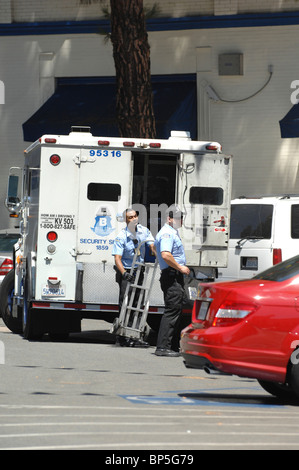 Armored car and currency delivery personnel enjoy their work while maintaining vigilance to maintain safety and security. Stock Photo