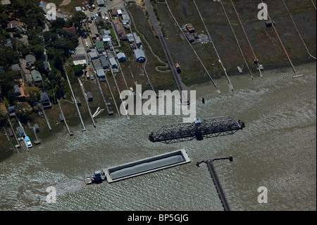 aerial view above tug boat pushing barge approaching swing bridge Petaluma river California Stock Photo