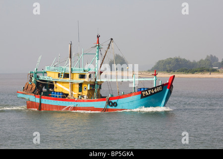 Fishing boat entering the mouth of the Kuantan River, Malaysia, just after dawn