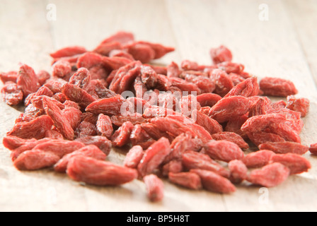 pile of red goji berries (Lycium chinense) on wooden board Stock Photo