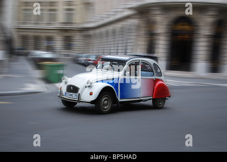 doing a tour of Paris in a classic Citroen 2CV of Paris Authentic. Stock Photo