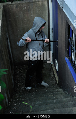 Burglar trying to break in to a house. Stock Photo